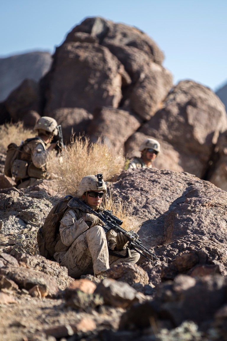 A Marine with Company “F”, 2nd Battalion, 1st Marine Regiment, provides security while the company hikes to their fighting position during a live fire company assault as part of Realistic Urban Training Exercise (RUTEX) at range 400 aboard Marine Corps Air Ground Combat Center Twenty-nine Palms, Calif., Sept. 5, 2015. RUTEX provides Marines and Sailors of the 13th Marine Expeditionary Unit (13th MEU) an opportunity to perform and practice their duties while deployed in an urban environment. (U.S. Marine Corps photo by Sgt Hector de Jesus/Released)