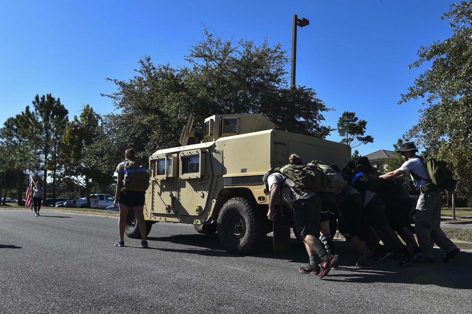 Airmen push a Humvee during a team cohesion challenge at Hurlburt Field, Fla., Sept. 25, 2015. The team cohesion challenge brought 28 individuals together for a 7-mile ruck march that included multiple, physically demanding tasks. (U.S. Air Force photo by Senior Airman Jeff Parkinson)