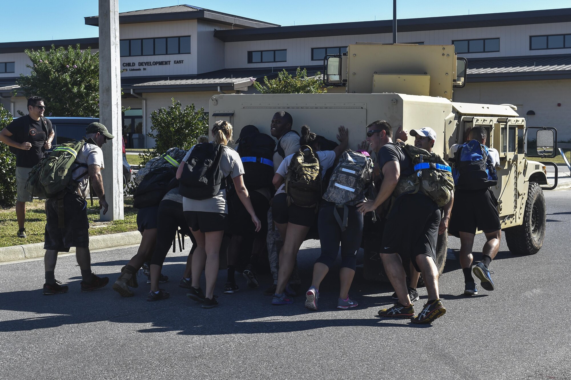 Airmen push a Humvee half of a mile during a team cohesion challenge at Hurlburt Field, Fla., Sept. 25, 2015. The team cohesion challenge is an event that challenges a group of random individuals to work together as a team to complete a task. (U.S. Air Force photo by Senior Airman Jeff Parkinson)
