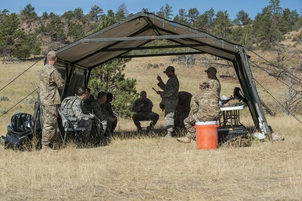 An Air Force Global Strike Command Challenge controller reads the rules for the Mental and Physical (MAP) Challenge on Sept. 22, 2015, Camp Guernsey Joint Training Center, Wyo. The MAP Challenge is a timed event, where Security Forces teams use their land navigation skills to reach check points, testing their team work and ability to complete objectives under harsh and stressful conditions. (U.S. Air Force photo by Master Sgt. Greg Steele/Released)