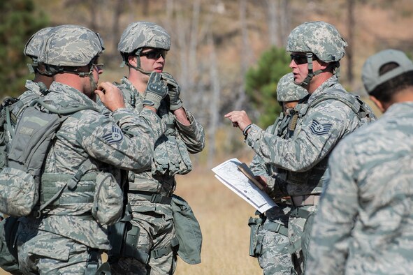 U.S. Air Force Tech. Sgt. Johnathan Maupin gives instructions to his team before the start of the Mental and Physical Challenge on Sept. 22, 2015, Camp Guernsey Joint Training Center, Wyo. Maupin is the leader of the six-person team and all are assigned to the 307th Security Forces Squadron at Barksdale Air Force Base, La. (U.S. Air Force photo by Master Sgt. Greg Steele/Released)