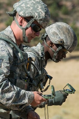 U.S. Air Force Tech. Sgt. Johnathan Maupin and Staff Sgt. Joshua Hill both check navigation directions to the first checkpoint during the Mental and Physical (MAP) Challenge on Sept. 22, 2015, Camp Guernsey Joint Training Center, Wyo. The MAP Challenge is a timed event, where Security Forces teams use their land navigation skills to reach check points, testing their team work and ability to complete objectives under harsh and stressful conditions. Both are assigned to the 307th Security Forces Squadron at Barksdale Air Force Base, La.  (U.S. Air Force photo by Master Sgt. Greg Steele/Released)