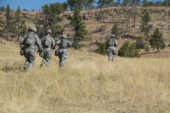 The 307th Security Forces Squadron competition team starts out on the first leg of the Mental and Physical (MAP) Challenge on Sept. 22, 2015, Camp Guernsey Joint Training Center, Wyo. The MAP Challenge is a timed event, where Security Forces teams use their land navigation skills to reach check points, testing their team work and ability to complete objectives under harsh and stressful conditions. (U.S. Air Force photo by Master Sgt. Greg Steele/Released)