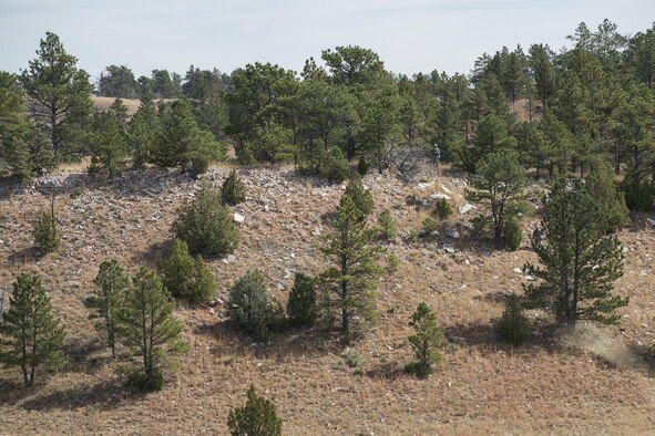 A member of the 307th Security Forces Squadron competition team navigates over rugged terrain during the Mental and Physical (MAP) Challenge on Sept. 22, 2015, Camp Guernsey Joint Training Center, Wyo. The MAP Challenge is a timed event, where Security Forces teams use their land navigation skills to reach check points, testing their team work and ability to complete objectives under harsh and stressful conditions. (U.S. Air Force photo by Master Sgt. Greg Steele/Released)