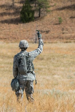 U.S. Air Force Staff Sgt. Joshua Hill motions to the members of his team during the Mental and Physical Challenge on Sept. 22, 2015, Camp Guernsey Joint Training Center, Wyo. Hill is assigned to the Air Force Reserve Command’s 307th Security Forces Squadron at Barksdale Air Force Base, La. (U.S. Air Force photo by Master Sgt. Greg Steele/Released)
