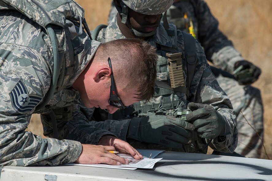 U.S. Air Force Tech. Sgt. Johnathan Maupin, 307th Security Forces Squadron calculates the direction of the next checkpoint during the Mental and Physical (MAP) Challenge on Sept. 22, 2015, Camp Guernsey Joint Training Center, Wyo. The MAP Challenge is a timed event, where Security Forces teams use their land navigation skills to reach check points, testing their team work and ability to complete objectives under harsh and stressful conditions. (U.S. Air Force photo by Master Sgt. Greg Steele/Released)