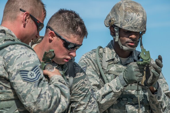 U.S. Air Force Staff Sgt. Joshua Hill calculates the direction of the next checkpoint during the Mental and Physical (MAP) Challenge on Sept. 22, 2015, Camp Guernsey Joint Training Center, Wyo. The MAP Challenge is a timed event, where Security Forces teams use their land navigation skills to reach check points, testing their team work and ability to complete objectives under harsh and stressful conditions. (U.S. Air Force photo by Master Sgt. Greg Steele/Released)
