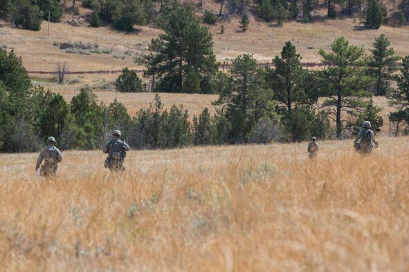 Members of the 307th Security Forces Squadron make their way to the next checkpoint during the Mental and Physical (MAP) Challenge on Sept. 22, 2015, Camp Guernsey Joint Training Center, Wyo. The MAP Challenge is a timed event, where Security Forces teams use their land navigation skills to reach check points, testing their team work and ability to complete objectives under harsh and stressful conditions. (U.S. Air Force photo by Master Sgt. Greg Steele/Released)