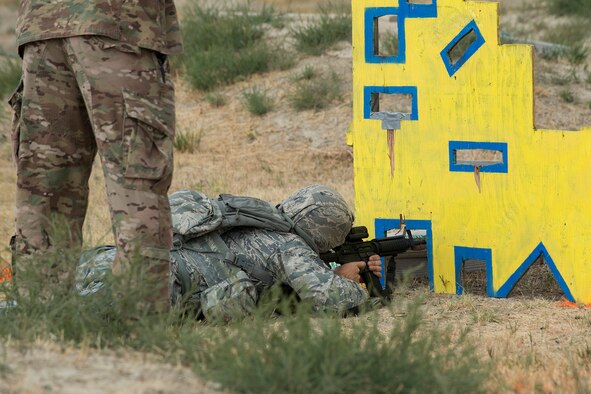 A member of the 307th Security Forces Squadron fires from an uncomfortable position during the Weapons Firing Challenge on Sept. 23, 2015, Camp Guernsey Joint Training Center, Wyo. The challenge consists of teams being evaluated on their marksmanship using the M4 rifle, M9 pistol, M240 machine gun and the M203 grenade launcher. (U.S. Air Force photo by Master Sgt. Greg Steele/Released)