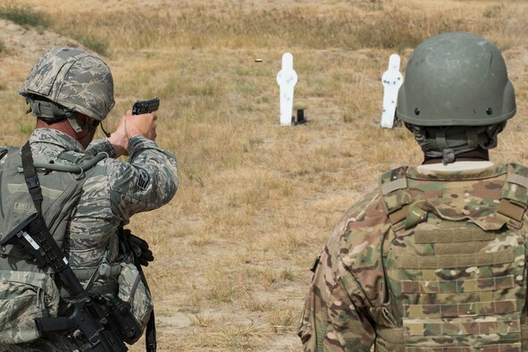A member of the 307th Security Forces Squadron fires his M9 pistol during the Weapons Firing Challenge on Sept. 23, 2015, Camp Guernsey Joint Training Center, Wyo. The challenge consists of teams being evaluated on their marksmanship using the M4 rifle, M9 pistol, M240 machine gun and the M203 grenade launcher. (U.S. Air Force photo by Master Sgt. Greg Steele/Released)