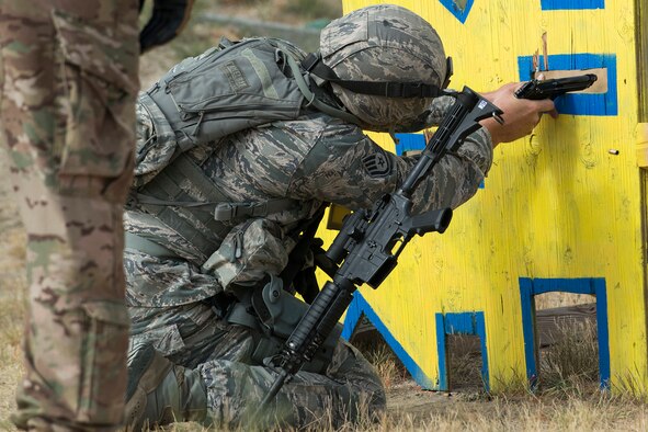 A member of the 307th Security Forces Squadron fires his M9 pistol during the Weapons Firing Challenge on Sept. 23, 2015, Camp Guernsey Joint Training Center, Wyo. The challenge consists of teams being evaluated on their marksmanship using the M4 rifle, M9 pistol, M240 machine gun and the M203 grenade launcher. (U.S. Air Force photo by Master Sgt. Greg Steele/Released)