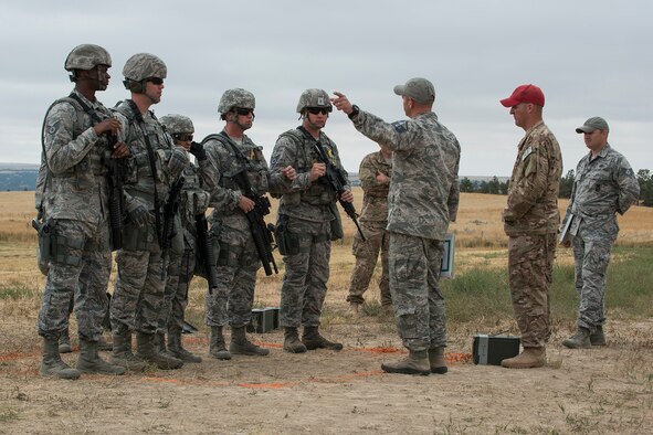 Members of the 307th Security Forces Squadron are briefed on the rules before the start of the Weapons Firing Challenge on Sept. 23, 2015, Camp Guernsey Joint Training Center, Wyo. The challenge consists of teams being evaluated on their marksmanship using the M4 rifle, M9 pistol, M240 machine gun and the M203 grenade launcher. (U.S. Air Force photo by Master Sgt. Greg Steele/Released)