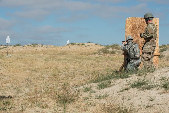 A member of the 307th Security Forces Squadron fires his M9 pistol during the Weapons Firing Challenge on Sept. 23, 2015, Camp Guernsey Joint Training Center, Wyo. The challenge consists of teams being evaluated on their marksmanship using the M4 rifle, M9 pistol, M240 machine gun and the M203 grenade launcher. (U.S. Air Force photo by Master Sgt. Greg Steele/Released)