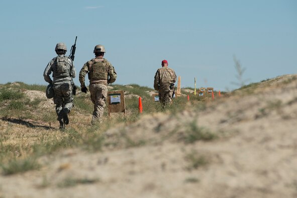 A member of the 307th Security Forces Squadron runs to the next station during the Weapons Firing Challenge on Sept. 23, 2015, Camp Guernsey Joint Training Center, Wyo. The challenge consists of teams being evaluated on their marksmanship using the M4 rifle, M9 pistol, M240 machine gun and the M203 grenade launcher. (U.S. Air Force photo by Master Sgt. Greg Steele/Released)