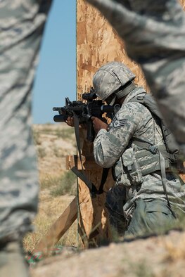 A member of the 307th Security Forces Squadron fires his M4 rifle during the Weapons Firing Challenge on Sept. 23, 2015, Camp Guernsey Joint Training Center, Wyo. The challenge consists of teams being evaluated on their marksmanship using the M4 rifle, M9 pistol, M240 machine gun and the M203 grenade launcher. (U.S. Air Force photo by Master Sgt. Greg Steele/Released)