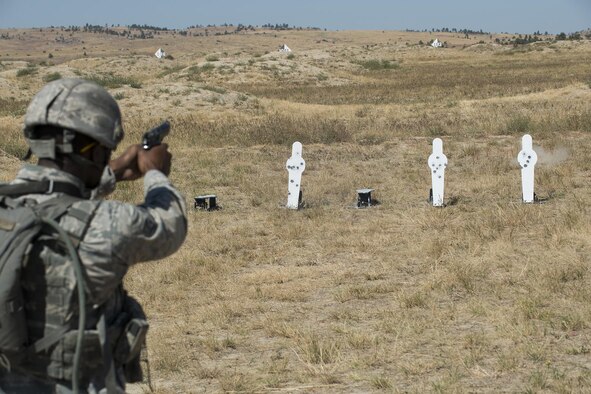 A member of the 307th Security Forces Squadron fires his M9 pistol during the Weapons Firing Challenge on Sept. 23, 2015, Camp Guernsey Joint Training Center, Wyo. The challenge consists of teams being evaluated on their marksmanship using the M4 rifle, M9 pistol, M240 machine gun and the M203 grenade launcher. (U.S. Air Force photo by Master Sgt. Greg Steele/Released)