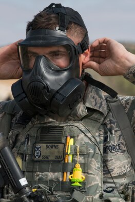 U.S. Air Force Staff Sgt. Paul Downs, 307th Security Forces Squadron, removes his Chemical Warfare Mask after completing the Weapons Firing Challenge on Sept. 23, 2015, Camp Guernsey Joint Training Center, Wyo. The challenge consists of teams being evaluated on their marksmanship using the M4 rifle, M9 pistol, M240 machine gun and the M203 grenade launcher. (U.S. Air Force photo by Master Sgt. Greg Steele/Released)