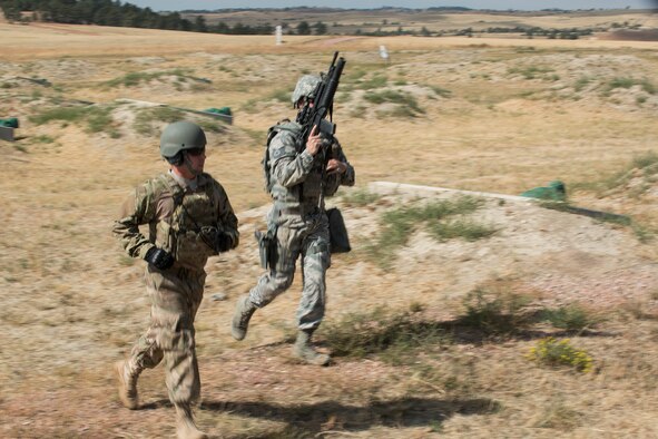 A member of the 307th Security Forces Squadron runs to the next station during the Weapons Firing Challenge on Sept. 23, 2015, Camp Guernsey Joint Training Center, Wyo. The challenge consists of teams being evaluated on their marksmanship using the M4 rifle, M9 pistol, M240 machine gun and the M203 grenade launcher. (U.S. Air Force photo by Master Sgt. Greg Steele/Released)