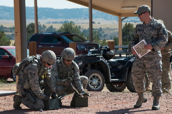 Members of the 307th Security Forces Squadron competition team prepare their ammo for the M240 machine gun firing competition during the Weapons Firing Challenge on Sept. 23, 2015, Camp Guernsey Joint Training Center, Wyo. The challenge consists of teams being evaluated on their marksmanship using the M4 rifle, M9 pistol, M240 machine gun and the M203 grenade launcher. (U.S. Air Force photo by Master Sgt. Greg Steele/Released)