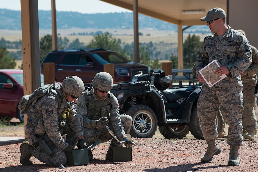 Members of the 307th Security Forces Squadron competition team prepare their ammo for the M240 machine gun firing competition during the Weapons Firing Challenge on Sept. 23, 2015, Camp Guernsey Joint Training Center, Wyo. The challenge consists of teams being evaluated on their marksmanship using the M4 rifle, M9 pistol, M240 machine gun and the M203 grenade launcher. (U.S. Air Force photo by Master Sgt. Greg Steele/Released)