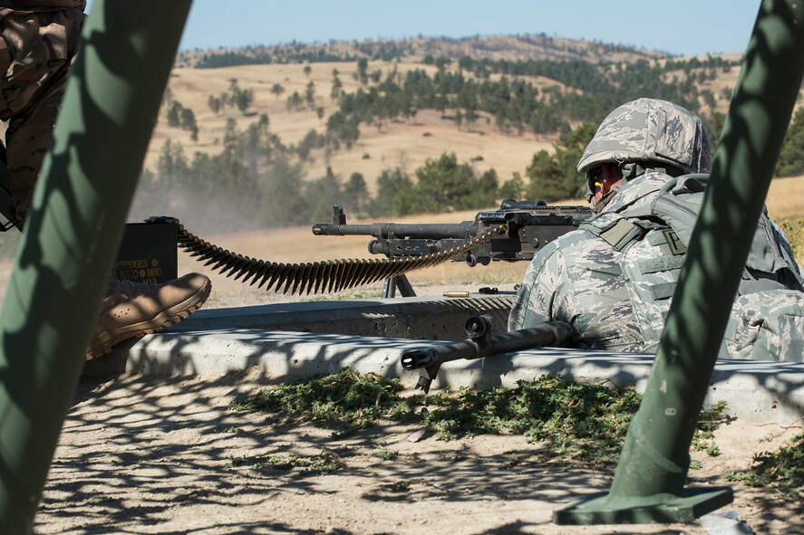 A member of the 307th Security Forces Squadron fires the M240 machine gun during the Weapons Firing Challenge on Sept. 23, 2015, Camp Guernsey Joint Training Center, Wyo. The challenge consists of teams being evaluated on their marksmanship using the M4 rifle, M9 pistol, M240 machine gun and the M203 grenade launcher. (U.S. Air Force photo by Master Sgt. Greg Steele/Released)