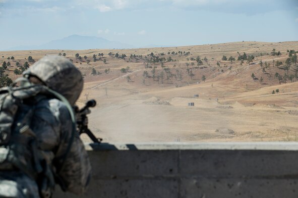 A member of the 307th Security Forces Squadron fires the M240 machine gun during the Weapons Firing Challenge on Sept. 23, 2015, Camp Guernsey Joint Training Center, Wyo. The challenge consists of teams being evaluated on their marksmanship using the M4 rifle, M9 pistol, M240 machine gun and the M203 grenade launcher. (U.S. Air Force photo by Master Sgt. Greg Steele/Released)