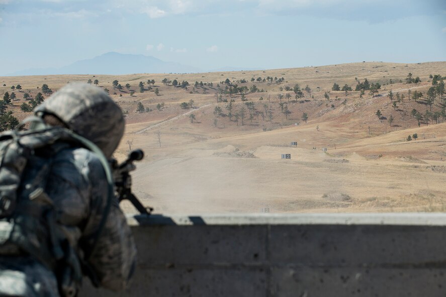 A member of the 307th Security Forces Squadron fires the M240 machine gun during the Weapons Firing Challenge on Sept. 23, 2015, Camp Guernsey Joint Training Center, Wyo. The challenge consists of teams being evaluated on their marksmanship using the M4 rifle, M9 pistol, M240 machine gun and the M203 grenade launcher. (U.S. Air Force photo by Master Sgt. Greg Steele/Released)