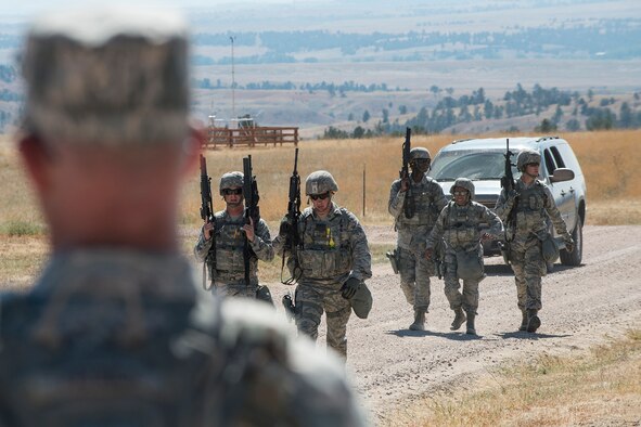 Members of the 307th Security Forces Squadron make their way to the next position during the Weapons Firing Challenge on Sept. 23, 2015, Camp Guernsey Joint Training Center, Wyo. The challenge consists of teams being evaluated on their marksmanship using the M4 rifle, M9 pistol, M240 machine gun and the M203 grenade launcher. (U.S. Air Force photo by Master Sgt. Greg Steele/Released)