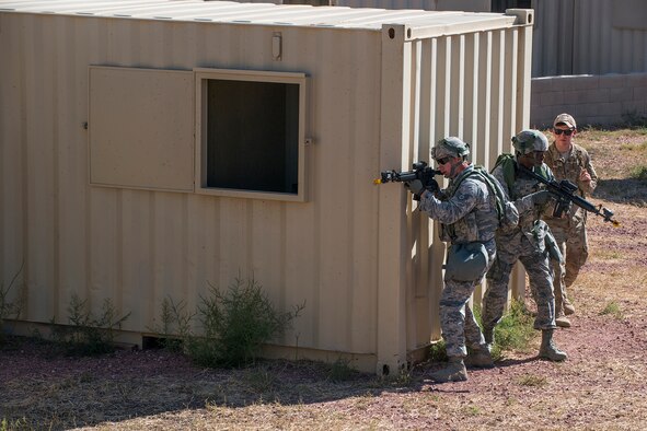 Members of the 307th Security Forces Squadron make their way through a compound during the Capture and Recovery Challenge on Sept. 24, 2015, Camp Guernsey Joint Training Center, Wyo. The challenge consists of teams eliminating enemy threats and securing a nuclear asset. (U.S. Air Force photo by Master Sgt. Greg Steele/Released)