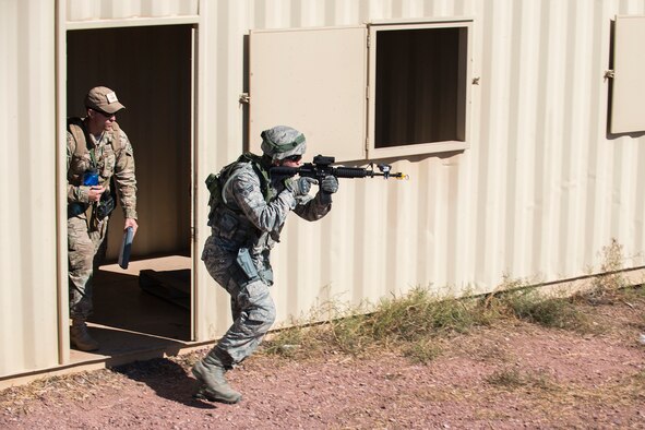 A member of the 307th Security Forces Squadron makes his way through a compound during the Capture and Recovery Challenge on Sept. 24, 2015, Camp Guernsey Joint Training Center, Wyo. The challenge consists of teams eliminating enemy threats and securing a nuclear asset. (U.S. Air Force photo by Master Sgt. Greg Steele/Released)