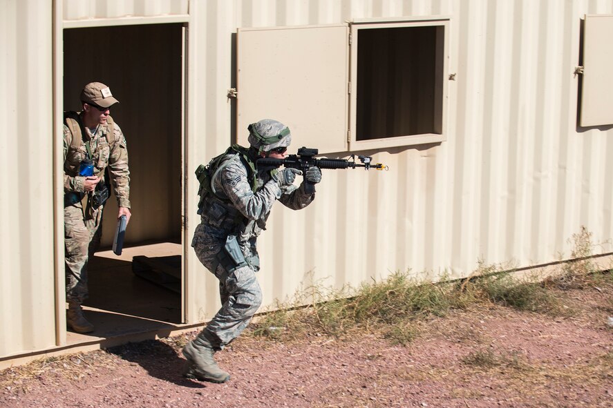 A member of the 307th Security Forces Squadron makes his way through a compound during the Capture and Recovery Challenge on Sept. 24, 2015, Camp Guernsey Joint Training Center, Wyo. The challenge consists of teams eliminating enemy threats and securing a nuclear asset. (U.S. Air Force photo by Master Sgt. Greg Steele/Released)