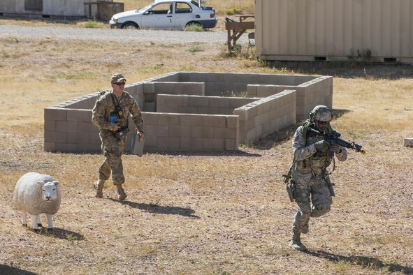 A member of the 307th Security Forces Squadron makes his way through a compound during the Capture and Recovery Challenge on Sept. 24, 2015, Camp Guernsey Joint Training Center, Wyo. The challenge consists of teams eliminating enemy threats and securing a nuclear asset. (U.S. Air Force photo by Master Sgt. Greg Steele/Released)