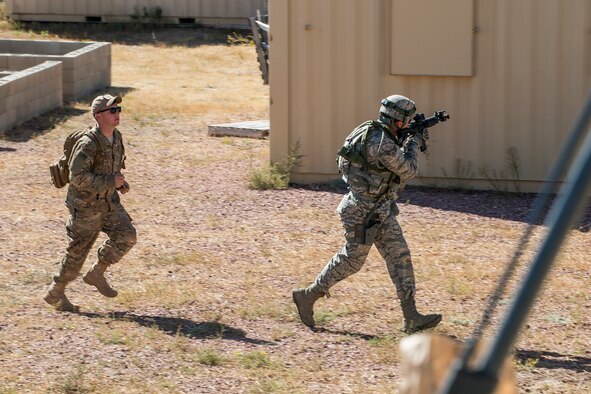 A member of the 307th Security Forces Squadron makes his way through a compound during the Capture and Recovery Challenge on Sept. 24, 2015, Camp Guernsey Joint Training Center, Wyo. The challenge consists of teams eliminating enemy threats and securing a nuclear asset. (U.S. Air Force photo by Master Sgt. Greg Steele/Released)