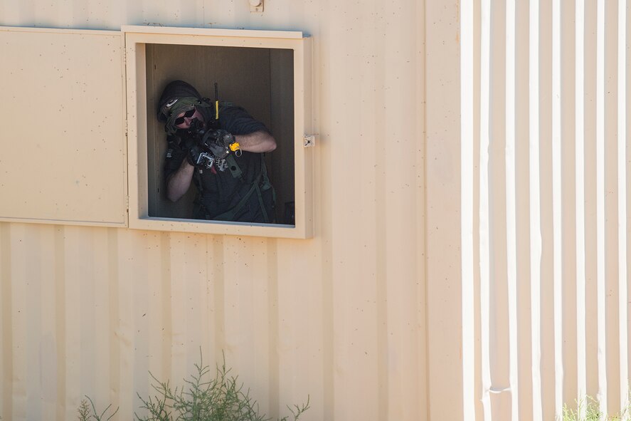 An enemy threat takes aim at a member of the 307th Security Forces Squadron during the Capture and Recovery Challenge on Sept. 24, 2015, Camp Guernsey Joint Training Center, Wyo. The challenge consists of teams eliminating enemy threats and securing a nuclear asset. (U.S. Air Force photo by Master Sgt. Greg Steele/Released)
