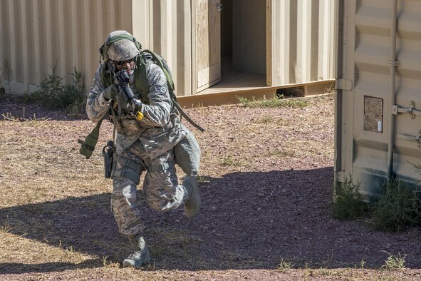 A member of the 307th Security Forces Squadron makes his way through a compound during the Capture and Recovery Challenge on Sept. 24, 2015, Camp Guernsey Joint Training Center, Wyo. The challenge consists of teams eliminating enemy threats and securing a nuclear asset. (U.S. Air Force photo by Master Sgt. Greg Steele/Released)