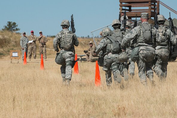 Members of the 307th Security Forces Squadron make their way to the next position during the Weapons Firing Challenge on Sept. 23, 2015, Camp Guernsey Joint Training Center, Wyo. The challenge consists of teams being evaluated on their marksmanship using the M4 rifle, M9 pistol, M240 machine gun and the M203 grenade launcher. (U.S. Air Force photo by Master Sgt. Greg Steele/Released)