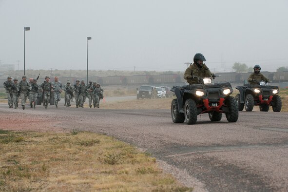 Security Forces members compete in the Warrior Run Challenge on Sept. 25, 2015, Camp Guernsey Joint Training Center, Wyo. The challenge consists of a team run, a HUMVEE push and a buddy carry through the finish line. (U.S. Air Force photo by Master Sgt. Greg Steele/Released)