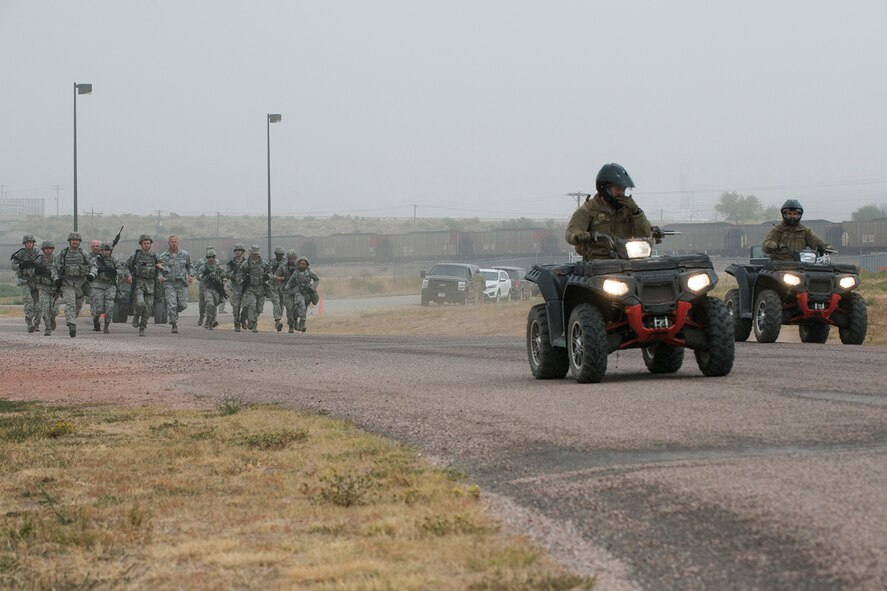 Security Forces members compete in the Warrior Run Challenge on Sept. 25, 2015, Camp Guernsey Joint Training Center, Wyo. The challenge consists of a team run, a HUMVEE push and a buddy carry through the finish line. (U.S. Air Force photo by Master Sgt. Greg Steele/Released)
