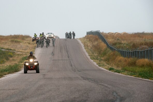 Security Forces members compete in the Warrior Run Challenge on Sept. 25, 2015, Camp Guernsey Joint Training Center, Wyo. The challenge consists of a team run, a HUMVEE push and a buddy carry through the finish line. (U.S. Air Force photo by Master Sgt. Greg Steele/Released)