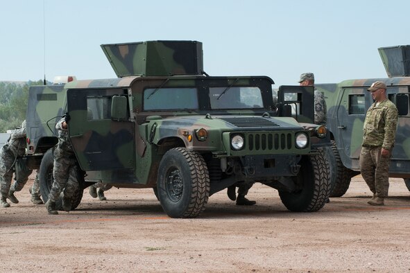 Members of the 307th Security Forces Squadron push a HUMVEE as part of the Warrior Run Challenge on Sept. 25, 2015, Camp Guernsey Joint Training Center, Wyo. The challenge consists of a team run, a HUMVEE push and a buddy carry through the finish line. (U.S. Air Force photo by Master Sgt. Greg Steele/Released)