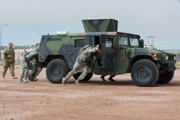 Members of the 307th Security Forces Squadron push a HUMVEE as part of the Warrior Run Challenge on Sept. 25, 2015, Camp Guernsey Joint Training Center, Wyo. The challenge consists of a team run, a HUMVEE push and a buddy carry through the finish line. (U.S. Air Force photo by Master Sgt. Greg Steele/Released)