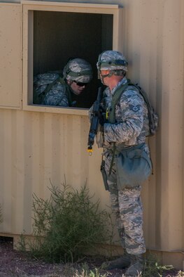 Members of the 307th Security Forces Squadron secure a building during the Capture and Recovery Challenge on Sept. 24, 2015, Camp Guernsey Joint Training Center, Wyo. The challenge consists of teams eliminating enemy threats and securing a nuclear asset. (U.S. Air Force photo by Master Sgt. Greg Steele/Released)
