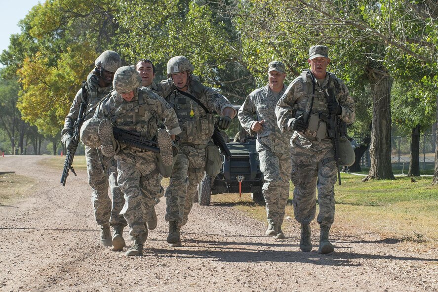 Members of the 307th Security Forces Squadron race for the finish line as part of the Warrior Run Challenge on Sept. 25, 2015, Camp Guernsey Joint Training Center, Wyo. The challenge consists of a team run, a HUMVEE push and a buddy carry through the finish line. (U.S. Air Force photo by Master Sgt. Greg Steele/Released)