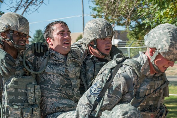 Members of the 307th Security Forces Squadron race for the finish line as part of the Warrior Run Challenge on Sept. 25, 2015, Camp Guernsey Joint Training Center, Wyo. The challenge consists of a team run, a HUMVEE push and a buddy carry through the finish line. (U.S. Air Force photo by Master Sgt. Greg Steele/Released)