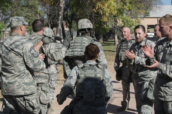 Members of the 307th Security Forces Squadron make it to the finish line as part of the Warrior Run Challenge on Sept. 25, 2015, Camp Guernsey Joint Training Center, Wyo. The challenge consists of a team run, a HUMVEE push and a buddy carry through the finish line. (U.S. Air Force photo by Master Sgt. Greg Steele/Released)