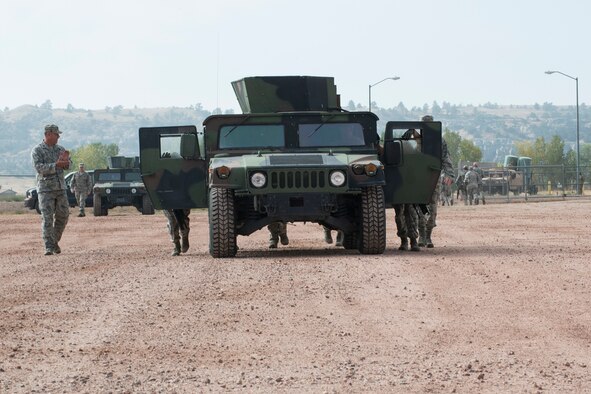 Members of the 307th Security Forces Squadron push a HUMVEE as part of the Warrior Run Challenge on Sept. 25, 2015, Camp Guernsey Joint Training Center, Wyo. The challenge consists of a team run, a HUMVEE push and a buddy carry through the finish line. (U.S. Air Force photo by Master Sgt. Greg Steele/Released)