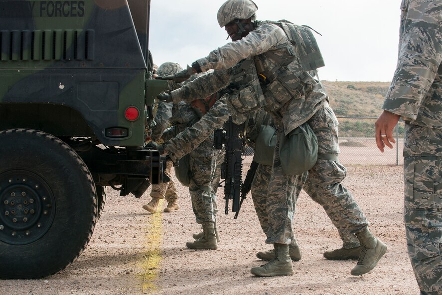 Members of the 307th Security Forces Squadron push a HUMVEE across the finish line as part of the Warrior Run Challenge on Sept. 25, 2015, Camp Guernsey Joint Training Center, Wyo. The challenge consists of a team run, a HUMVEE push and a buddy carry through the finish line. (U.S. Air Force photo by Master Sgt. Greg Steele/Released)