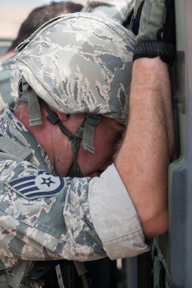 U.S. Air Force Staff Sgt. Paul Downs, 307th Security Forces Squadron, catches his breath after his team pushed a HUMVEE as part of the Warrior Run Challenge on Sept. 25, 2015, Camp Guernsey Joint Training Center, Wyo. The challenge consists of a team run, a HUMVEE push and a buddy carry through the finish line. (U.S. Air Force photo by Master Sgt. Greg Steele/Released)