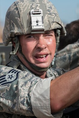 U.S. Air Force Staff Sgt. Paul Downs, 307th Security Forces Squadron, catches his breath after his team pushed a HUMVEE as part of the Warrior Run Challenge on Sept. 25, 2015, Camp Guernsey Joint Training Center, Wyo. The challenge consists of a team run, a HUMVEE push and a buddy carry through the finish line. (U.S. Air Force photo by Master Sgt. Greg Steele/Released)