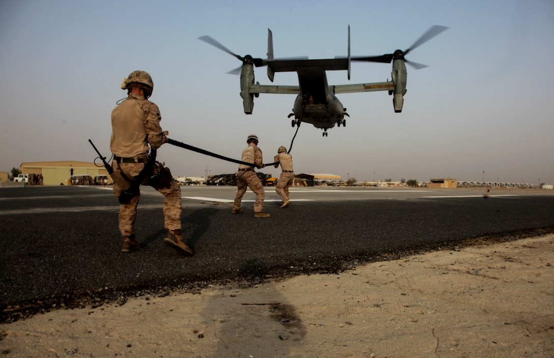 U.S. Marine Helicopter Rope Suspension Training Masters with India Company, 3rd Battalion, 7th Marine Regiment, Special Purpose Marine Air-Ground Task Force—Crisis Response—Central Command, stabilize a rope from an MV-22 Osprey during fast rope training while deployed to Southwest Asia, Sept. 16, 2015. Fast roping allows Marines to insert ground forces quickly from the air, without the need for a stabilized landing zone. The Marines and Sailors of SPMAGTF-CR-CC provide the commander of USCENTCOM with a unique set of solutions to emergent crises across a broad swath of the Middle East. 
